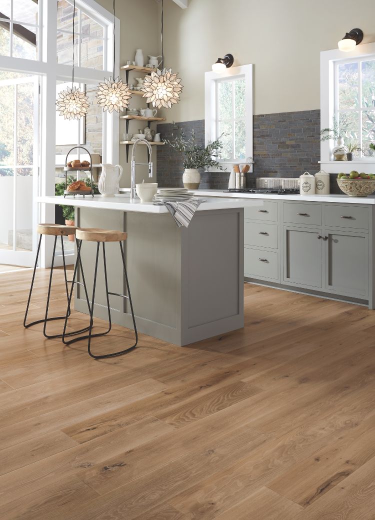 kitchen design with grey cabinets, wood look floors, dark tile backsplash, and stone countertops