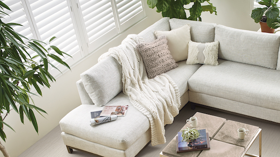 white wood blinds in a bright living room